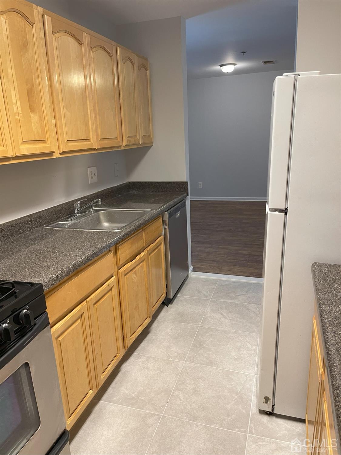 1113 Edpas Road New Brunswick, NJ 08901 - Photo 4 of 13 a kitchen with stainless steel appliances granite countertop a refrigerator a stove and a sink