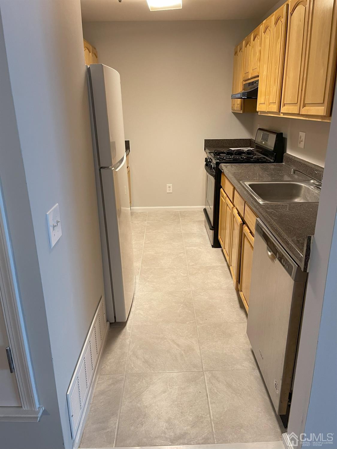 1113 Edpas Road New Brunswick, NJ 08901 - Photo 7 of 13 a kitchen with a sink a refrigerator a stove and a washer dryer