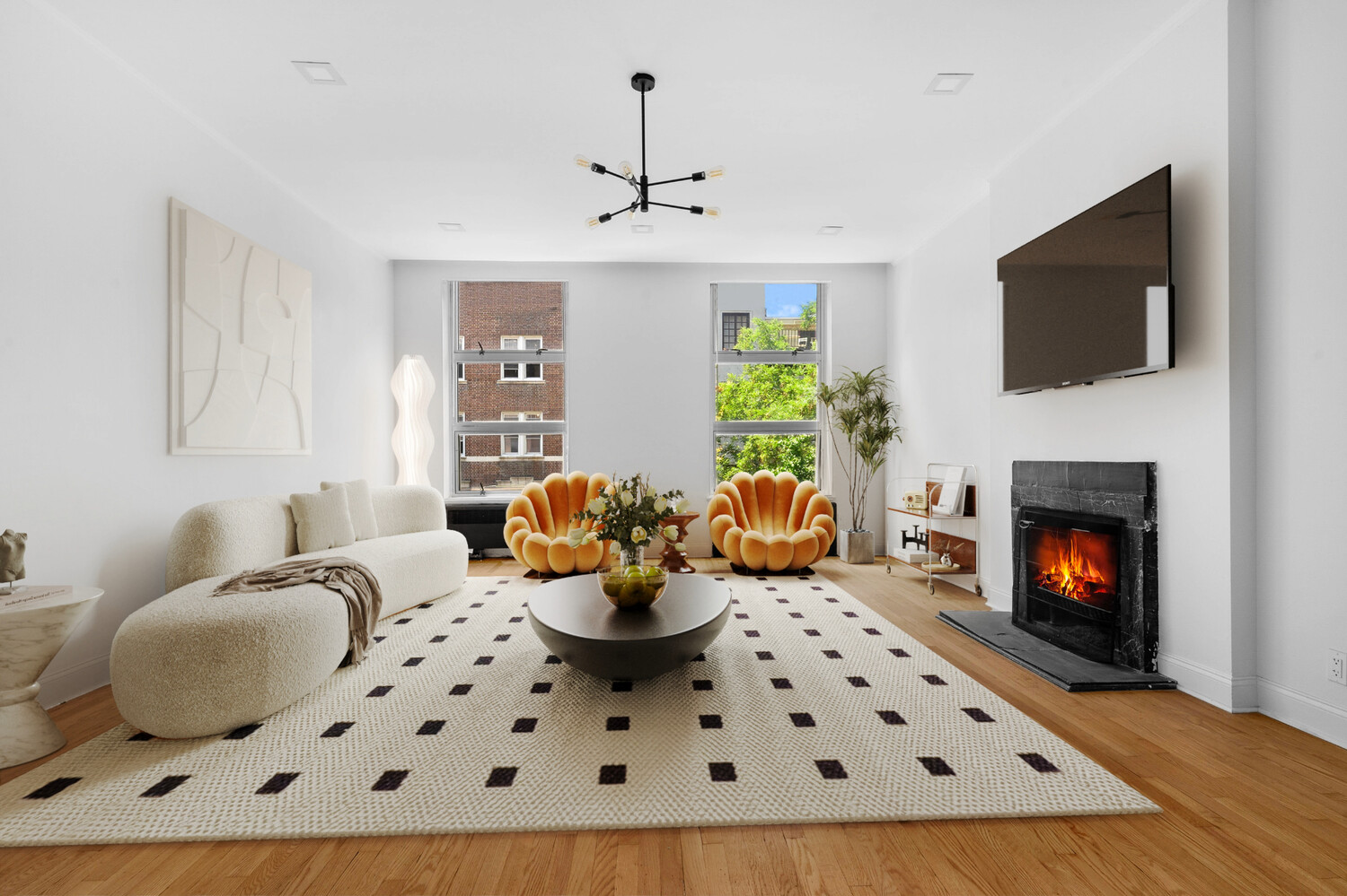 33 West 9th Street Manhattan, NY 10011 - Photo 1 of 15 a living room with furniture a flat screen tv and a fireplace