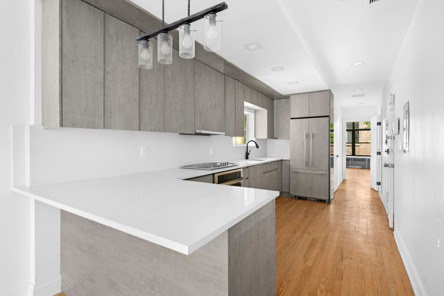 33 West 9th Street Manhattan, NY 10011 - Photo 2 of 15 a view of a kitchen with wooden floor
