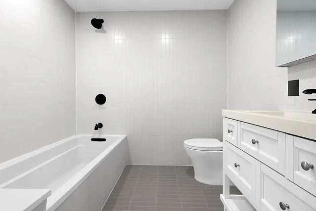 a bedroom with a bed windows and book shelf