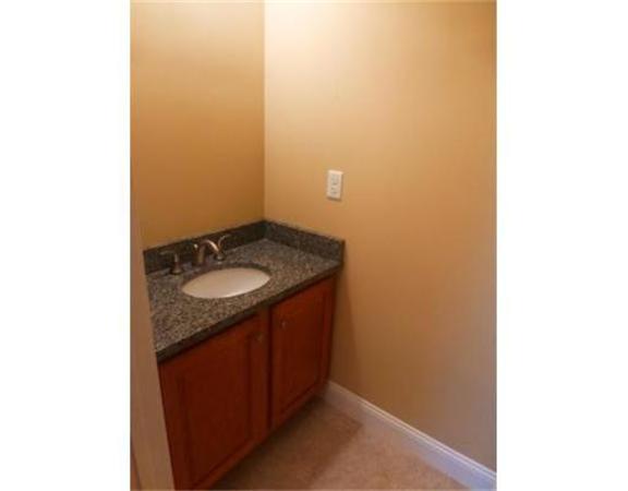 53 Baldwin Road, Unit 1402 Billerica, MA 01821 - Photo 13 of 30 a bathroom with a granite countertop sink and a mirror