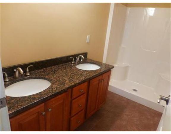 53 Baldwin Road, Unit 1402 Billerica, MA 01821 - Photo 16 of 30 a bathroom with a granite countertop sink and a mirror