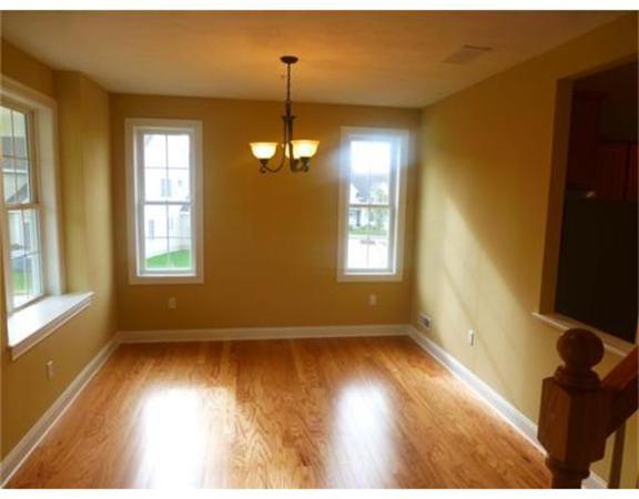 53 Baldwin Road, Unit 1402 Billerica, MA 01821 - Photo 5 of 30 a view of an empty room with wooden floor and a window
