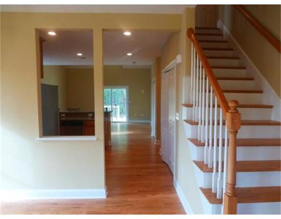 53 Baldwin Road, Unit 1402 Billerica, MA 01821 - Photo 8 of 30 a view of a hallway with wooden floor and staircase