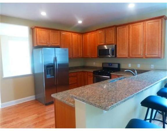 53 Baldwin Road, Unit 1402 Billerica, MA 01821 - Photo 10 of 30 a kitchen with stainless steel appliances granite countertop a refrigerator a stove top oven a sink and dishwasher