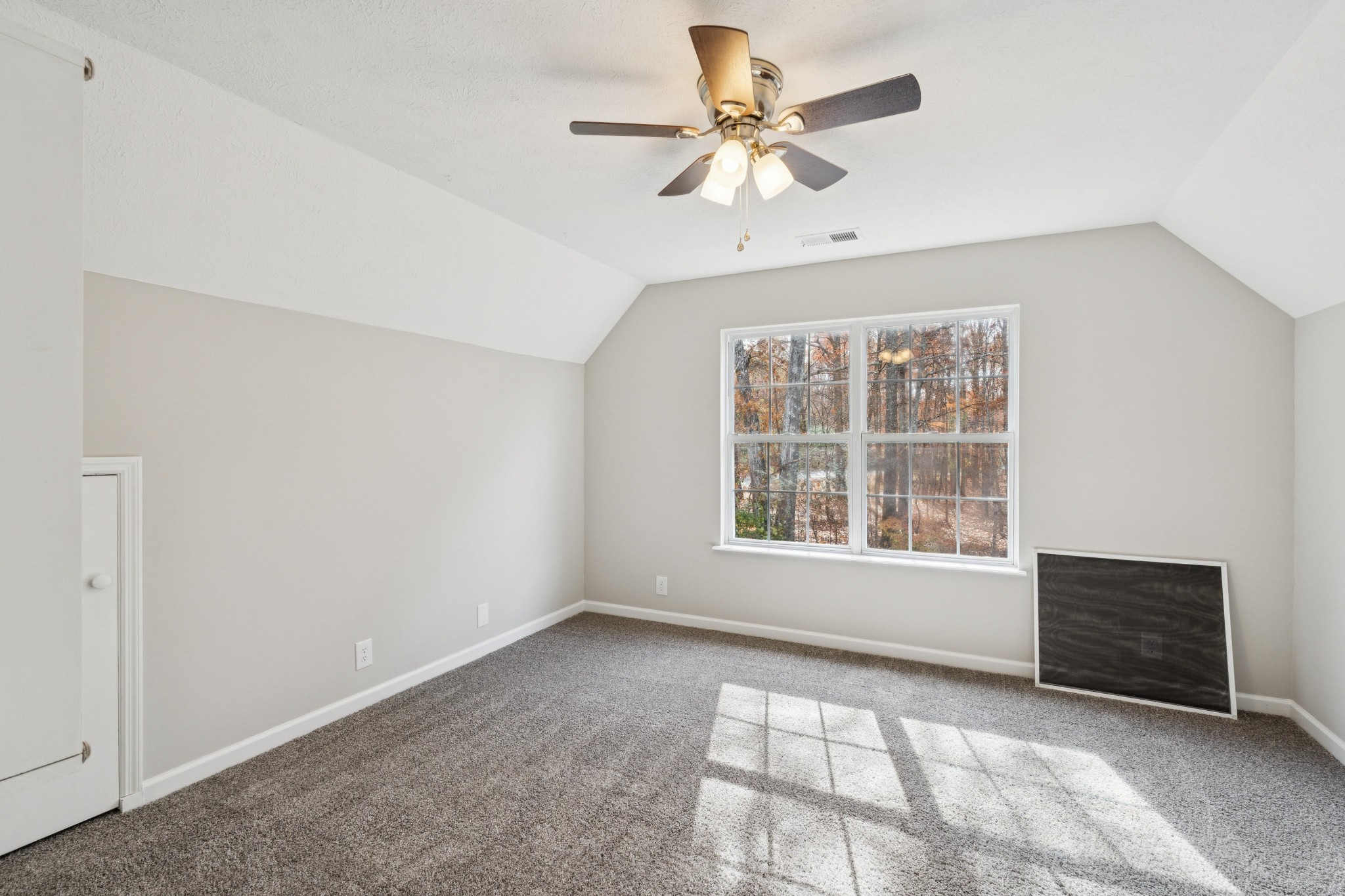 163 Monteagle Falls Road Monteagle, TN 37356 - Photo 20 of 35 an empty room with chandelier fan and windows