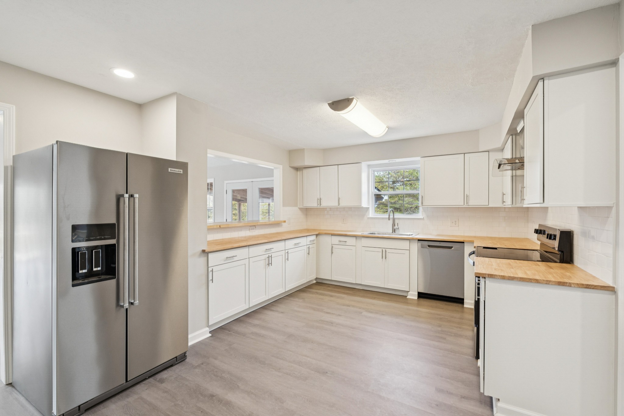 163 Monteagle Falls Road Monteagle, TN 37356 - Photo 4 of 35 a kitchen with a refrigerator sink and cabinets