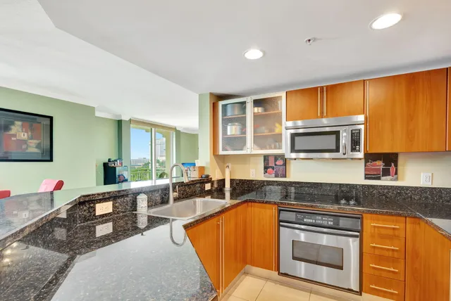 a kitchen with stainless steel appliances granite countertop sink stove and granite counter top