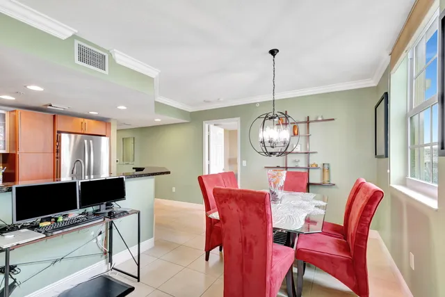 a dining room with furniture a chandelier and window