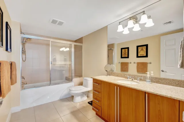 a spacious bathroom with a granite countertop sink toilet and shower