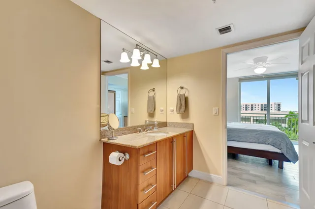 a spacious bathroom with a granite countertop sink and a mirror
