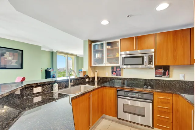 a kitchen with stainless steel appliances granite countertop sink stove and granite counter top