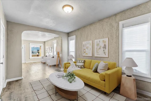 a living room with furniture and wooden floor