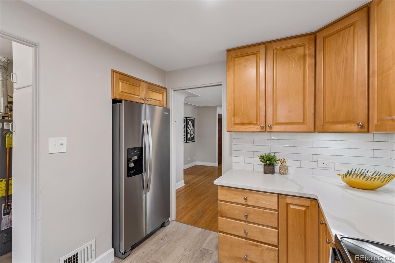 2255 Meade Street Denver, CO 80211 - Photo 12 of 30 a kitchen with stainless steel appliances granite countertop a refrigerator and a sink