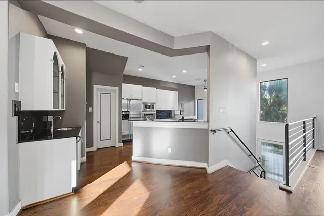 a kitchen with white cabinets and stainless steel appliances