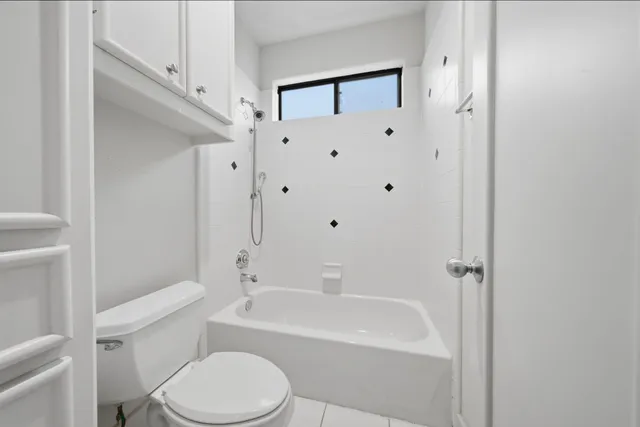 a white toilet sitting next to a bathroom sink
