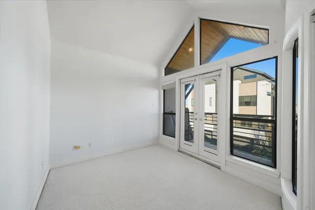 a view of a hallway with wooden walls and floor to ceiling window