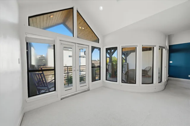 a large white kitchen with granite countertop a sink and dishwasher a stove with cabinets