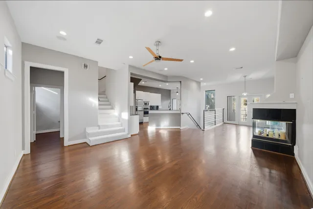 a view of a living room or kitchen with a fireplace and window