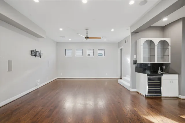 a view of a kitchen with wooden floor and a sink