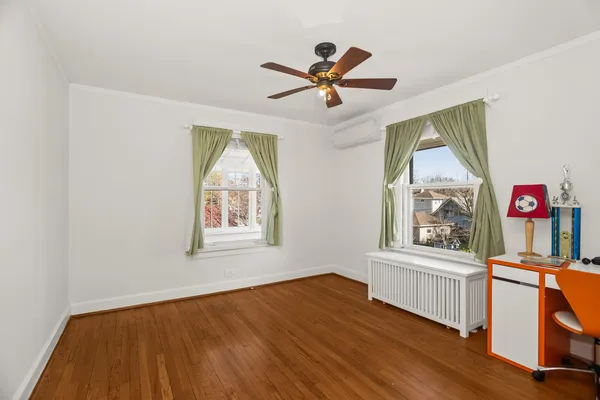 a living room with wooden floors and a window