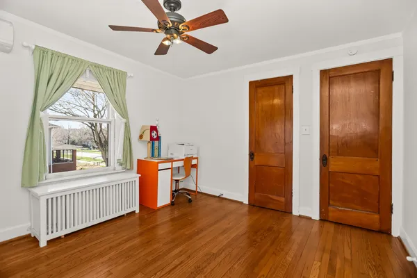 a view of a livingroom with furniture window wooden floor and a ceiling fan