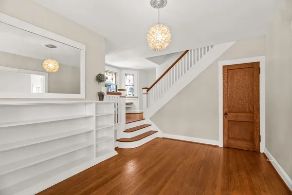 a view of entryway and hall with wooden floor