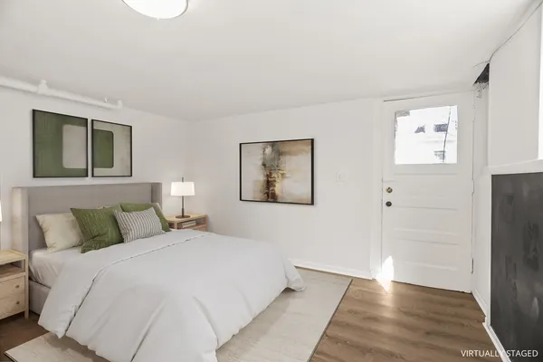 a bedroom with a bed and a painting on the wall