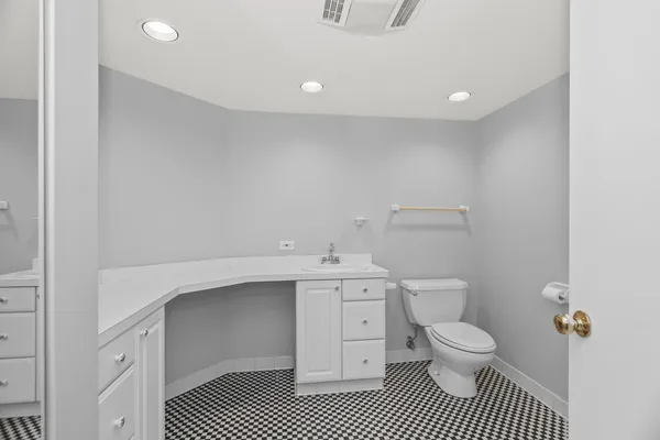 a bathroom with a sink a toilet and a shower