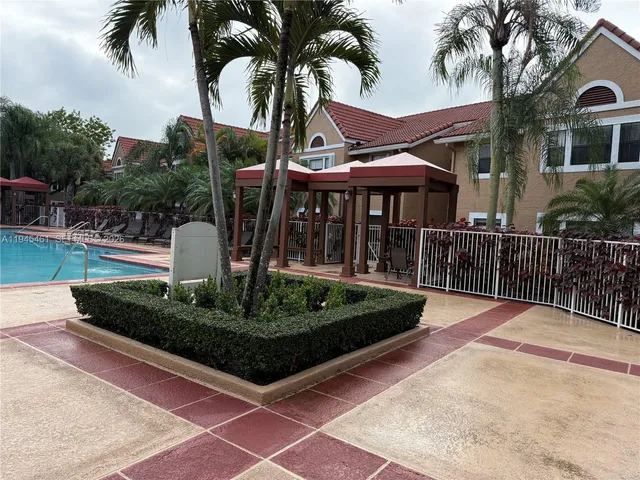 a view of a house with backyard and sitting area
