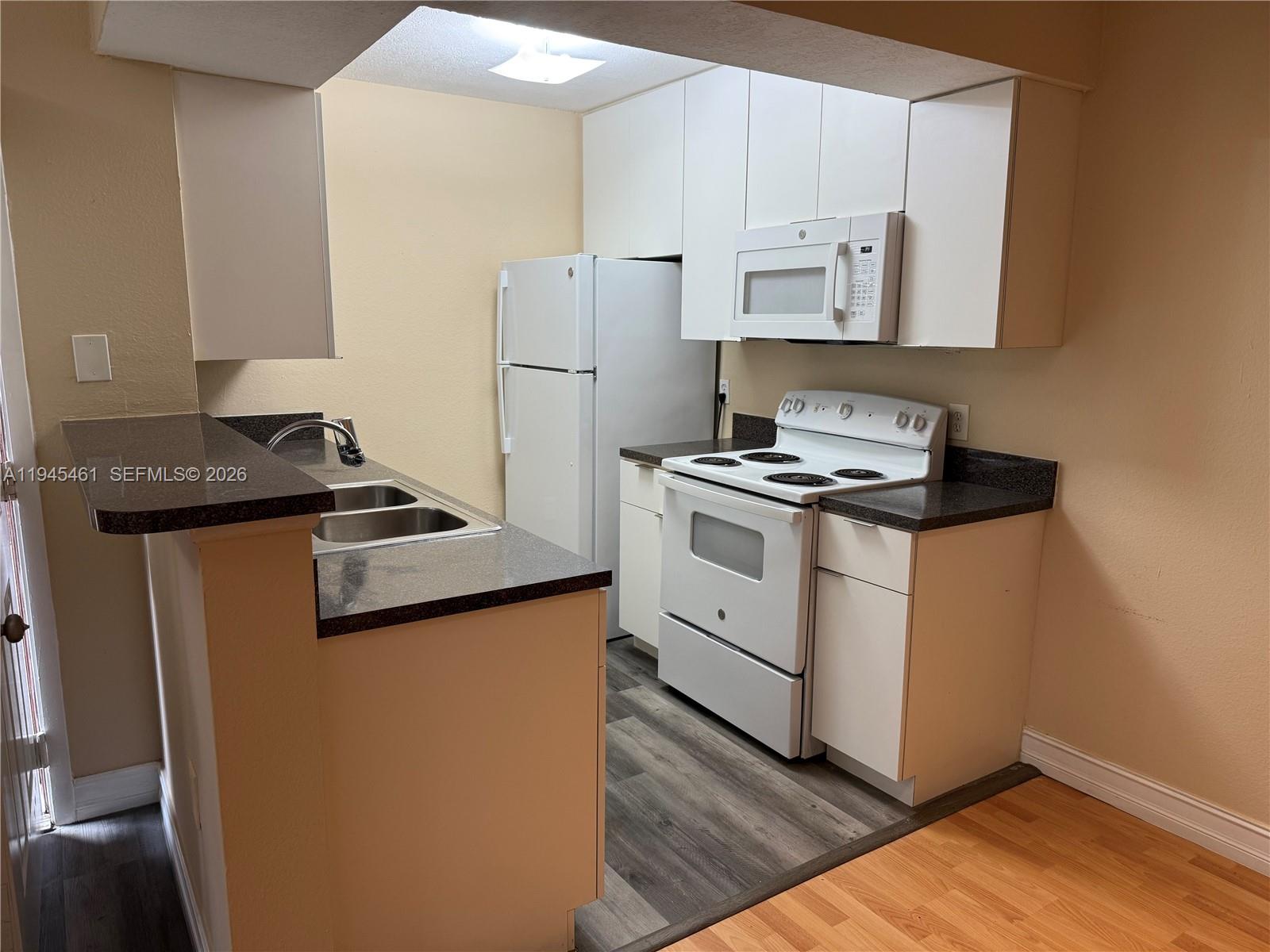 10441 Southwest 156th Court, Unit 429 Miami, FL 33196 - Photo 7 of 17 a kitchen with a stove and a refrigerator