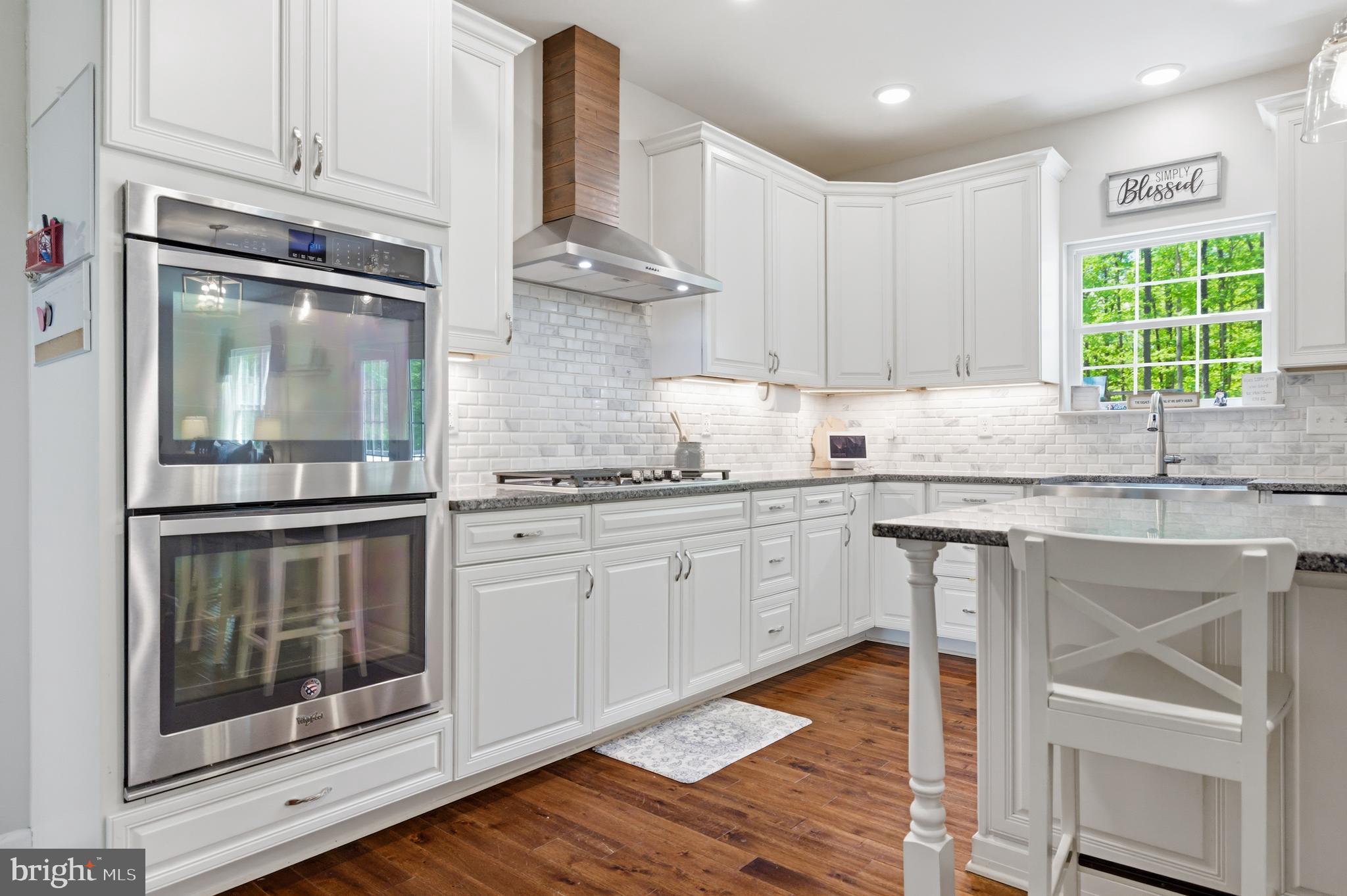 6324 Vint Hill Road Warrenton, VA 20187 - Photo 35 of 103 a kitchen with granite countertop white cabinets and window