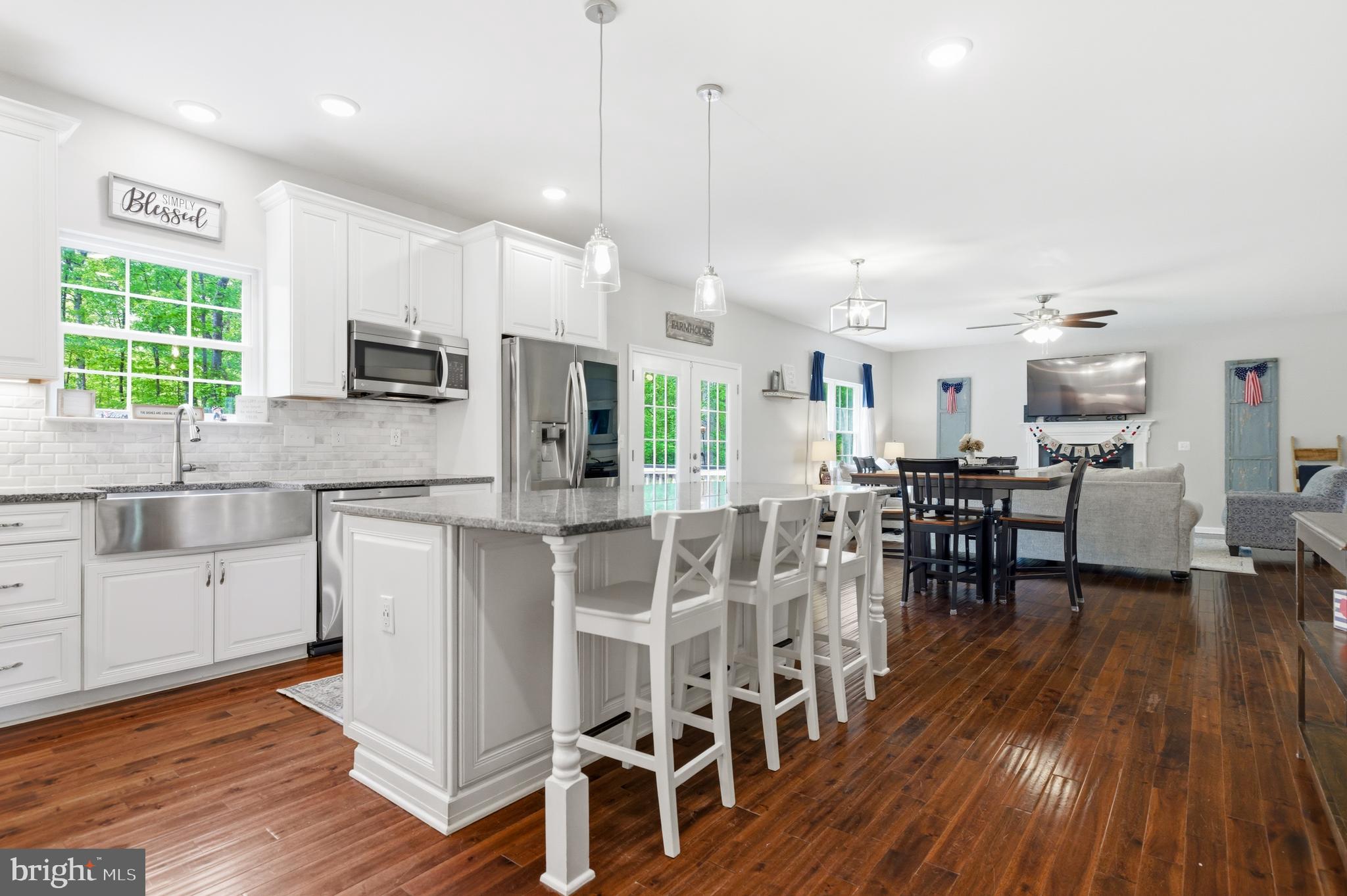 6324 Vint Hill Road Warrenton, VA 20187 - Photo 41 of 103 a kitchen with stainless steel appliances kitchen island granite countertop a table chairs sink and cabinets