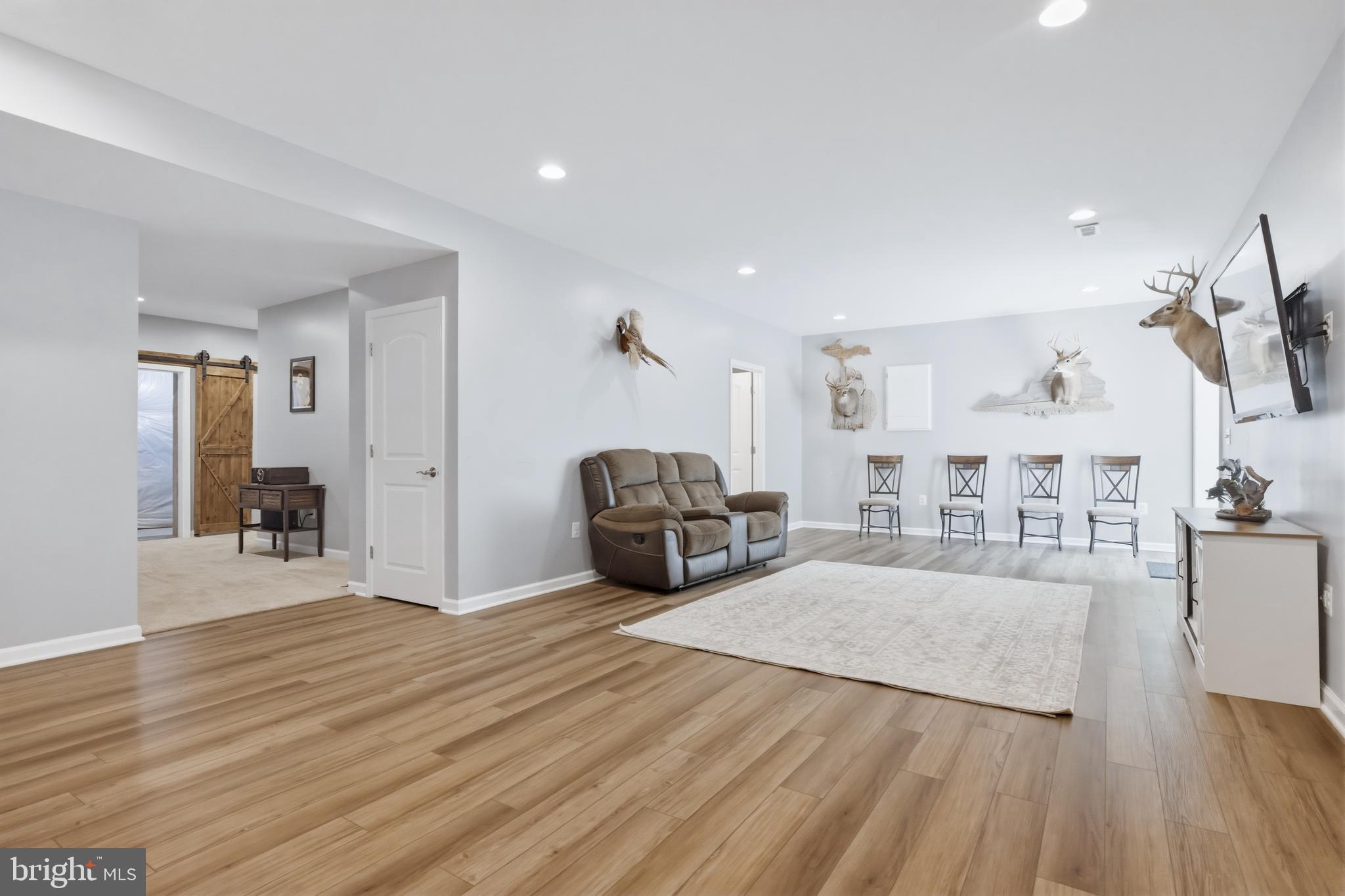 6324 Vint Hill Road Warrenton, VA 20187 - Photo 77 of 103 a living room with furniture and a wooden floor