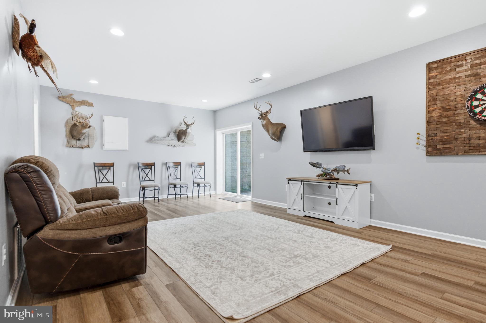 6324 Vint Hill Road Warrenton, VA 20187 - Photo 78 of 103 a living room with furniture and a flat screen tv