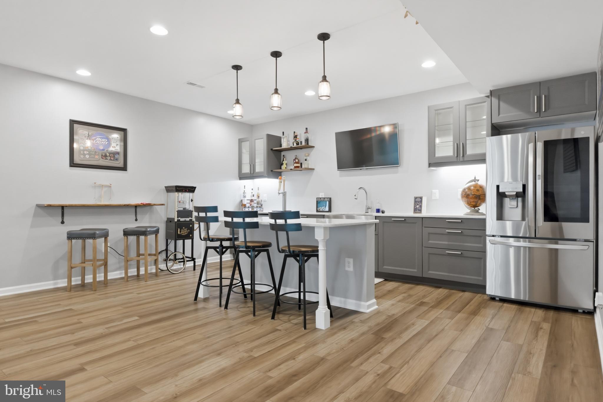 6324 Vint Hill Road Warrenton, VA 20187 - Photo 81 of 103 a kitchen with stainless steel appliances granite countertop a refrigerator a stove a sink dishwasher and a dining table with wooden floor