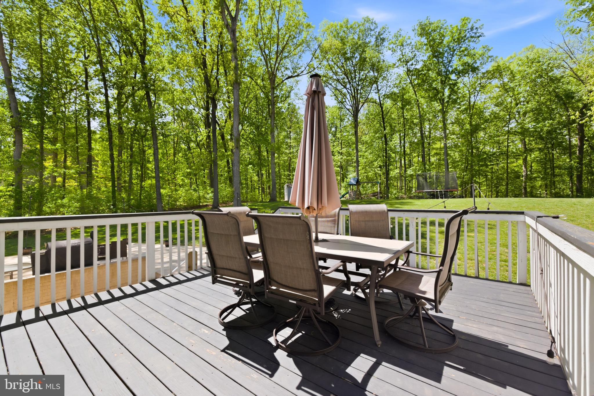 6324 Vint Hill Road Warrenton, VA 20187 - Photo 98 of 103 a view of a deck with table and chairs and wooden floor