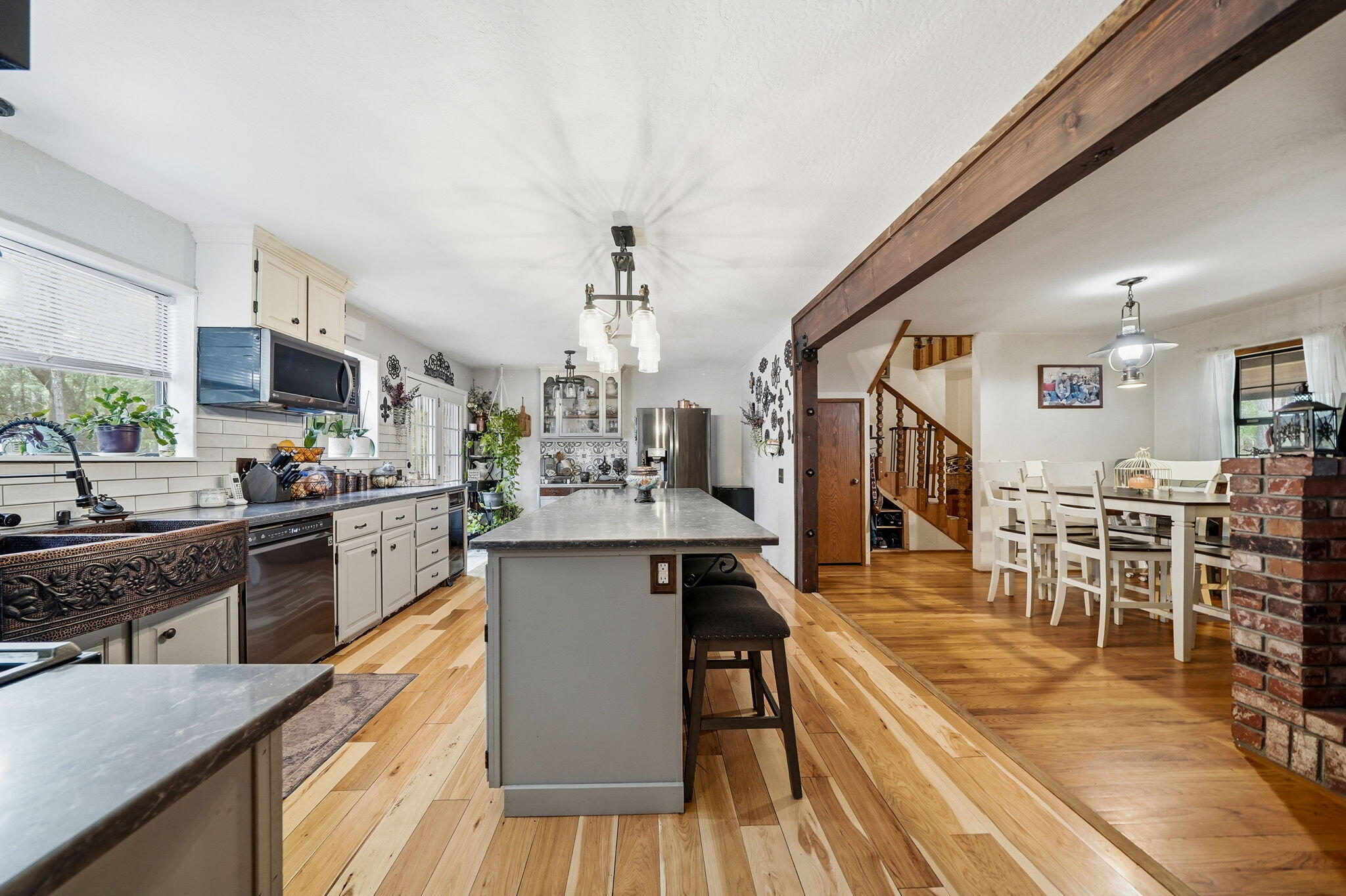 7758 Hidden Meadows Road Shingletown, CA 96088 - Photo 16 of 63 a kitchen with stainless steel appliances granite countertop a table chairs stove a sink dishwasher and cabinets with wooden floor