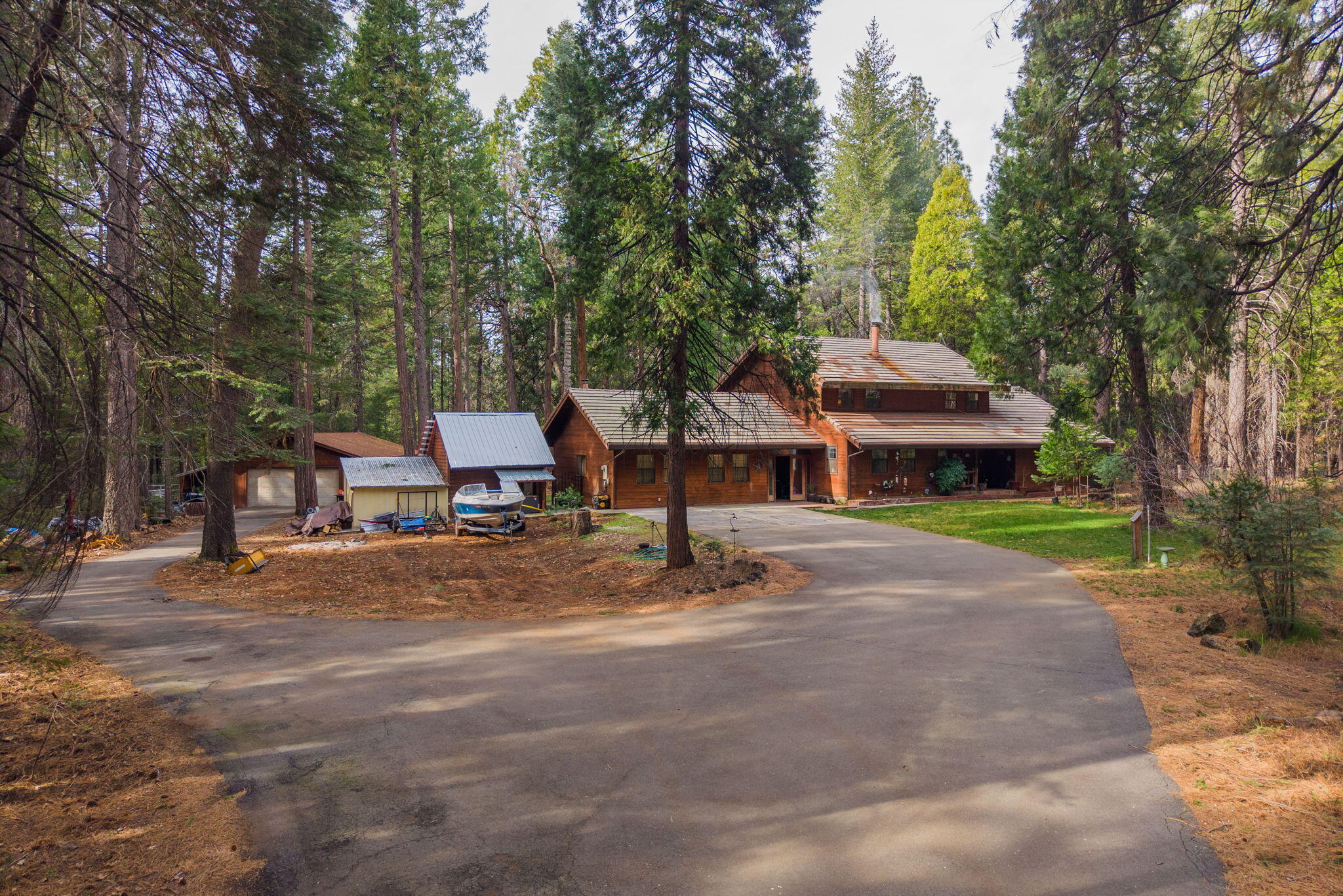 7758 Hidden Meadows Road Shingletown, CA 96088 - Photo 55 of 63 a front view of a house with a garden and trees