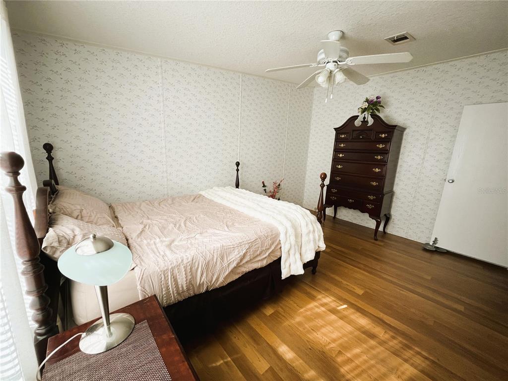 7750 156th Terrace Live Oak, FL 32060 - Photo 24 of 41 a bedroom with a bed a table and chair