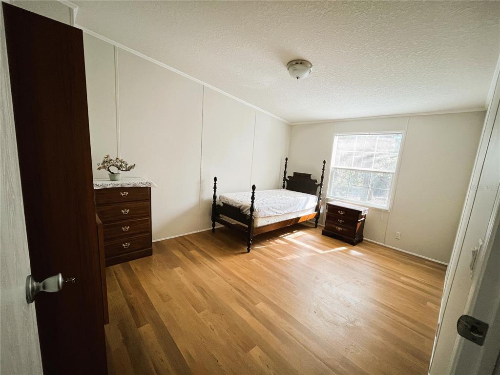 7750 156th Terrace Live Oak, FL 32060 - Photo 26 of 41 wooden floor and chair in a room