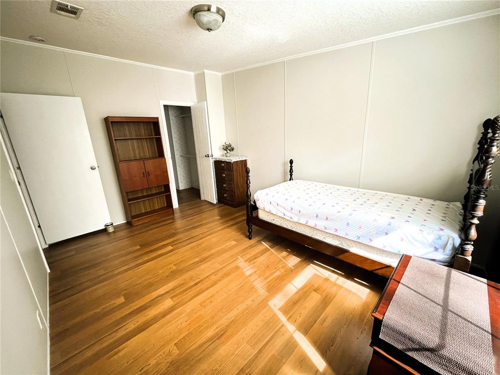 7750 156th Terrace Live Oak, FL 32060 - Photo 27 of 41 a bedroom with a bed and a refrigerator