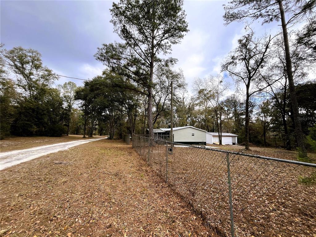 7750 156th Terrace Live Oak, FL 32060 - Photo 3 of 41 a view of a outdoor space with trees