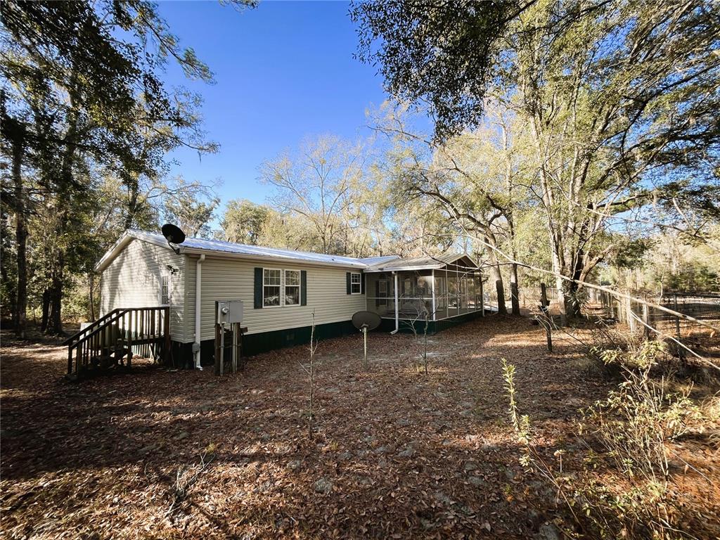 7750 156th Terrace Live Oak, FL 32060 - Photo 4 of 41 a view of a house with a yard