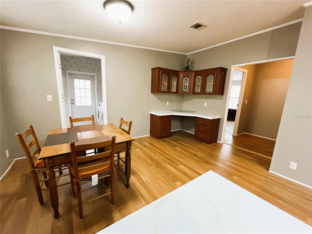 7750 156th Terrace Live Oak, FL 32060 - Photo 10 of 41 a view of a dining room with furniture and wooden floor