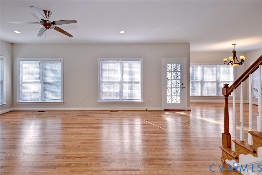 11385 Winding River Road Providence Forge, VA 23140 - Photo 21 of 43 a view of an empty room with wooden floor and a window