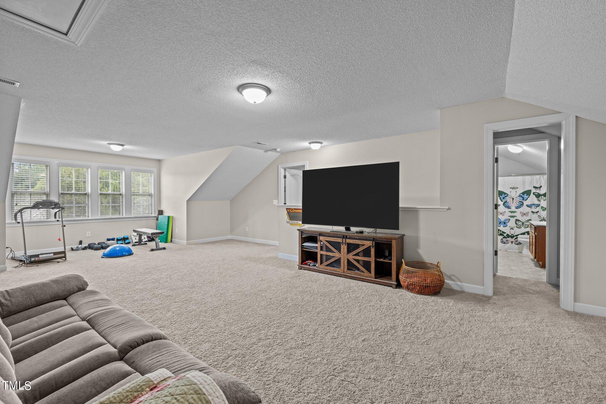 8809 Oregon Inlet Court Raleigh, NC 27603 - Photo 11 of 53 a living room with furniture and a flat screen tv