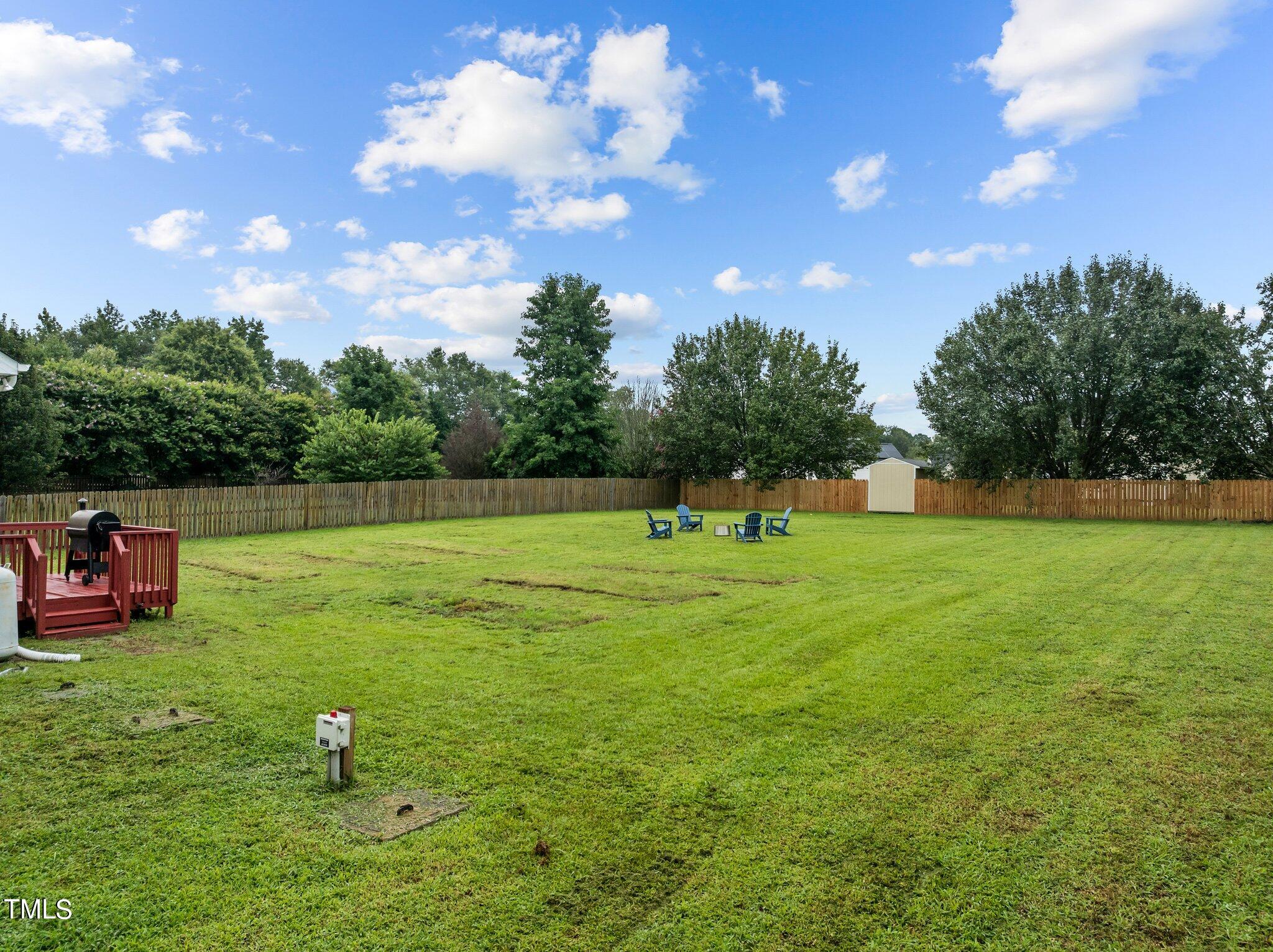 8809 Oregon Inlet Court Raleigh, NC 27603 - Photo 52 of 53 a backyard of a house with lots of green space