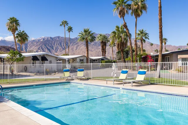 a view of swimming pool with sitting area and slide